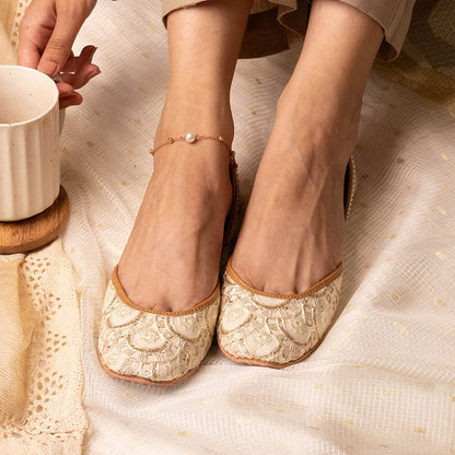Coral Haze Ivory And Gold Threadwork Juttis With Gold Fringe Detailing At The Back