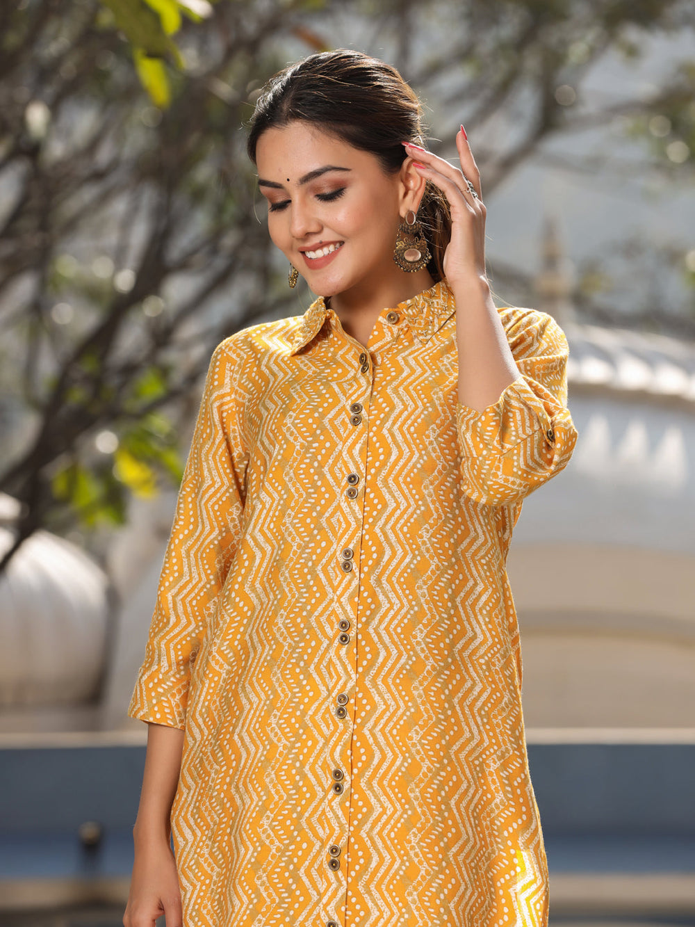 Women mustard chanderi printed Kurta has a shirt collar and hand embroidery, front placket has buttons, three fourth rolled up sleeves, side slit, straight hem, high - low pattern.
