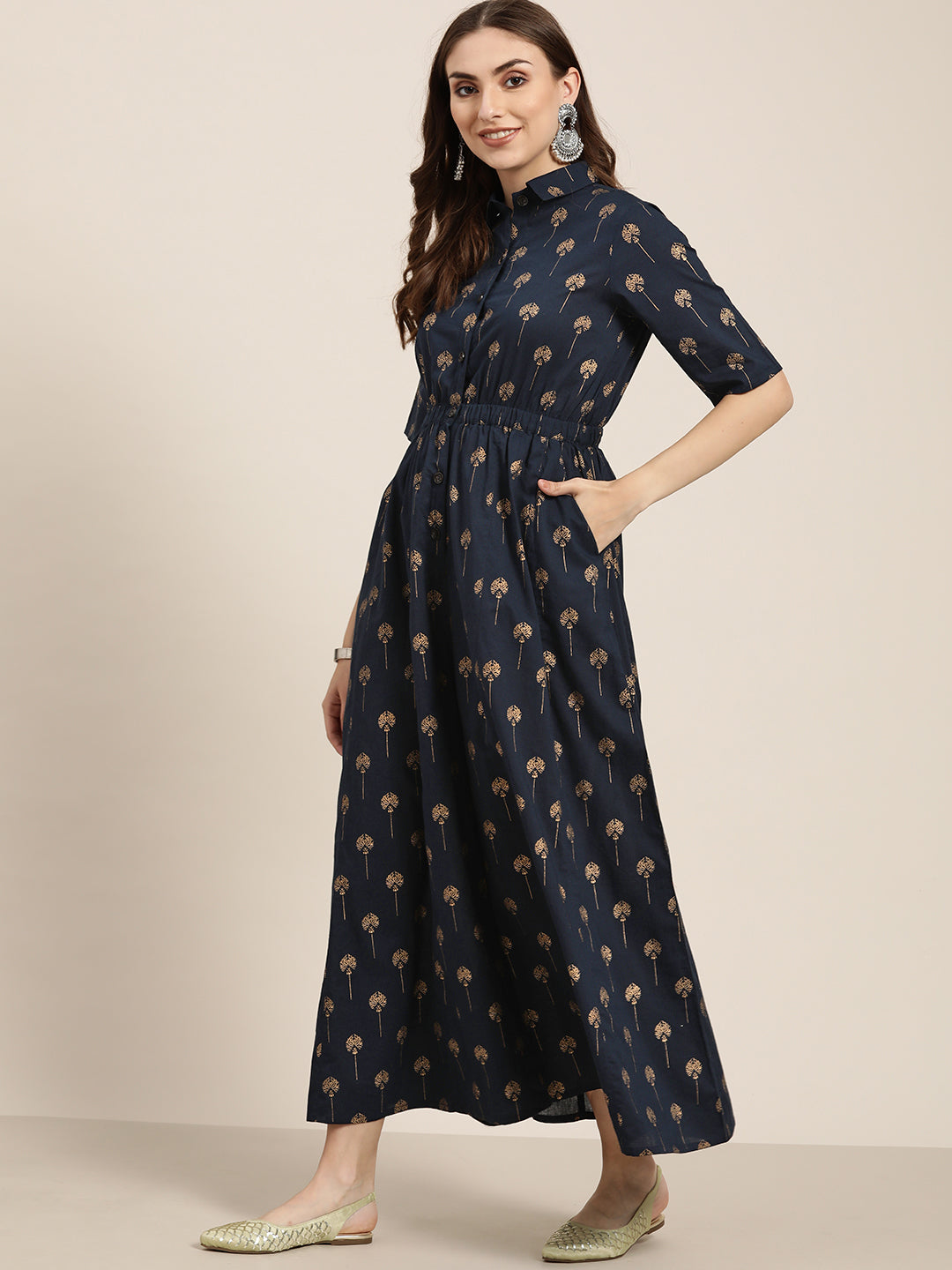 Blue Gold Print Cotton Waist Elasticated Flared Jumpsuit Has Spread Collar With Front Button Opening, Elastic At Waist, Elbow Sleeves, Flared Hemline.