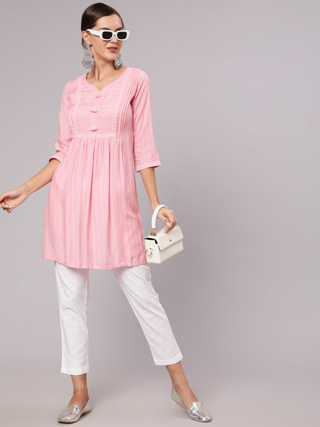 Pink Self Weave Pleated And Laced-Up Short Kurta With Tassels And Lace In Yoke, Round Neck With Notch, Pleats At Both Side Of Front Neck, Three Fourth Sleeve, Gathers In Front, Side Slit.