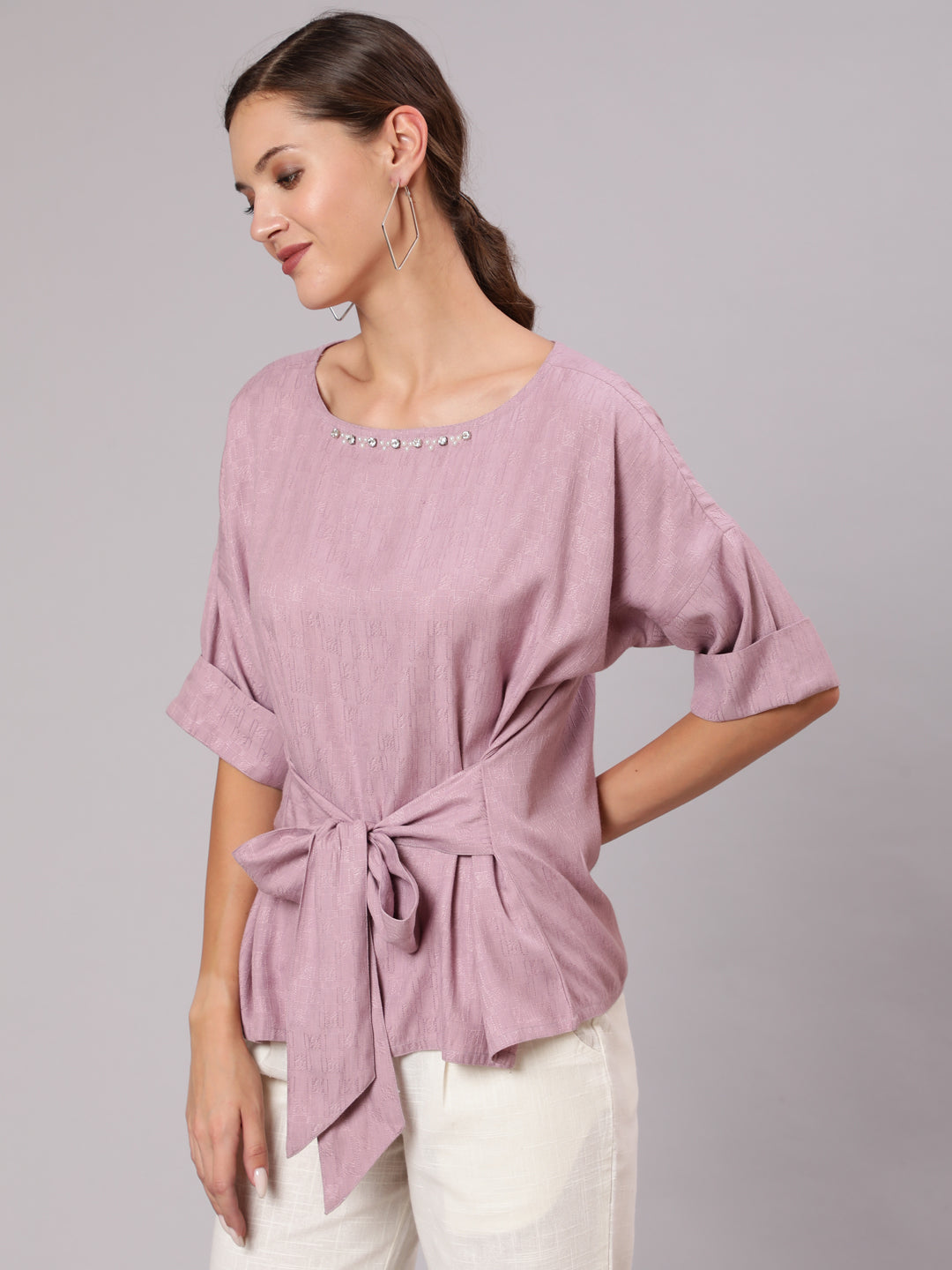 A Mauve Color Self Weaved Embellished Top With Tie-Up At The Waist And Extended Sleeves Top With Cotton White Flared Pants