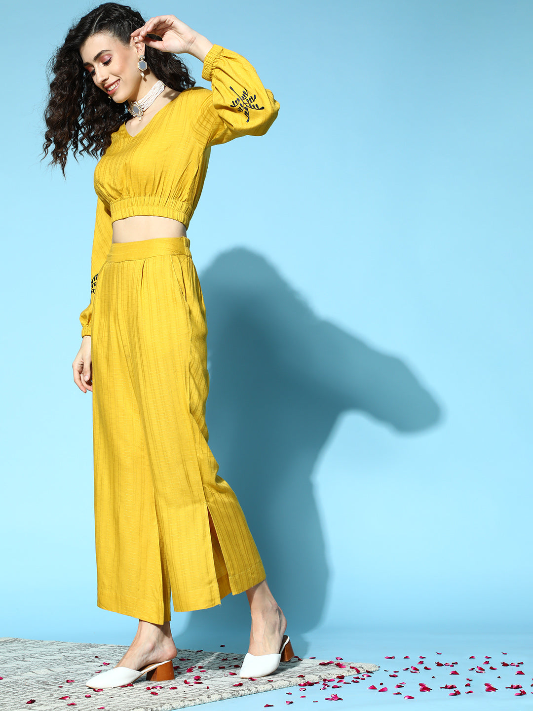 Women Mustard Self Weave Rayon Co-ords Set Has Crop Top With Round Neck, Elastic At Waistline, Gathers All Over At Waist, Full Sleeves Has Elastic At The Hem, Thread Embroidery At Sleeves, Mustard Palazzo Has Flared Hem With Side Slit, Both Side Pocket And Partially Elastic At Waistline