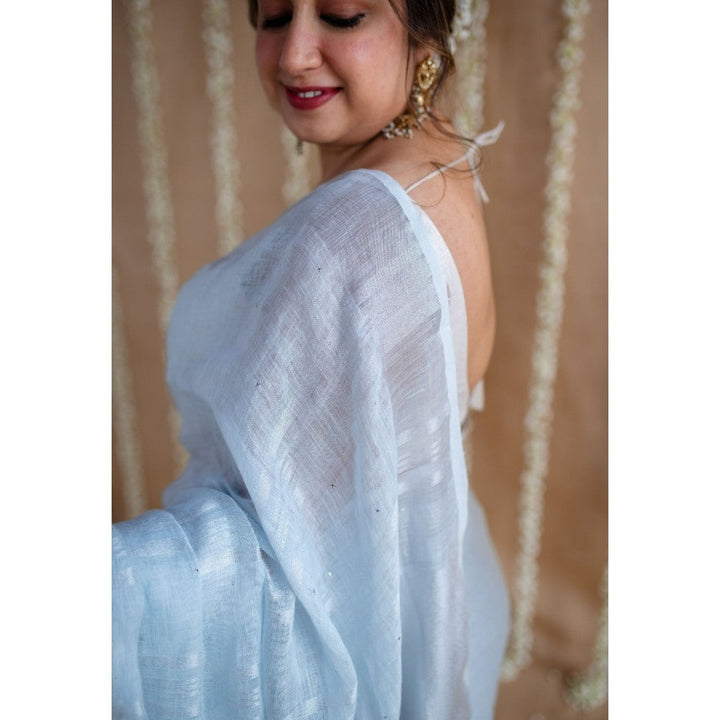 The Indian Ethnic Co. Blue Linen Silver Zari Border Saree & Unstitched Blouse with Mukaish Detailing